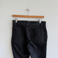 Load image into Gallery viewer, We The Free Raw Hem Denim High Rise Flared Jeans Black 30