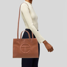 Load image into Gallery viewer, Telfar Large Faux Leather Embossed Logo Snap Closure Crossbody Bag Brown
